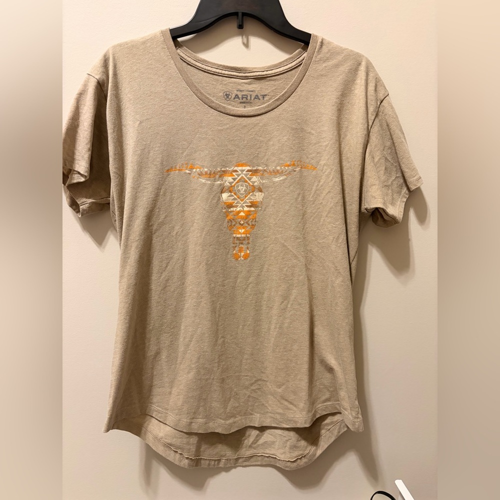 Ariat Light Brown T-Shirt with orange and white cattle Logo